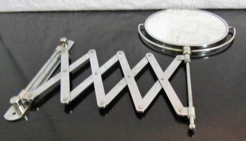A Very useful scissor arm mirror. This mirror has incredible patina.