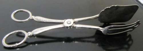 A Italian silver plate ornate serving tongs. Scissor style tongs with a ornate design on the handle