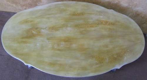 A STUNNING ORNATE TABLE WITH WOODEN TOP AND CASTED LEGS