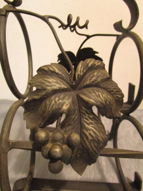 A lovely and large vintage wrought iron wine bottle holder, wine rack or bottle carrier for 3 bottel