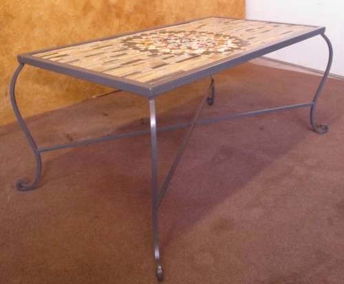 A GORGEOUS OUTDOOR TABLE WITH STEEL LEGS AND FRAME WITH A SOLLID MOSAIC TOP