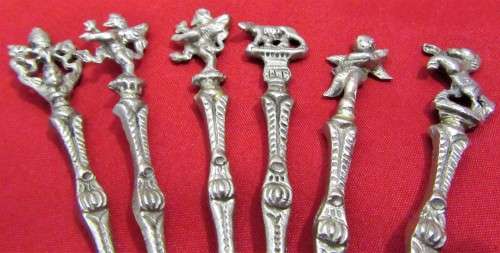 A VERY ORNATE SET OF 6 DESERT OR TEA SPOONS DECORATED WITH FIGURES & ANGELS VERY DIFFERENT