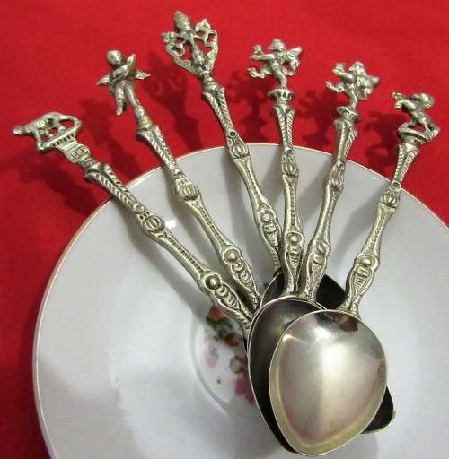 A VERY ORNATE SET OF 6 DESERT OR TEA SPOONS DECORATED WITH FIGURES & ANGELS VERY DIFFERENT