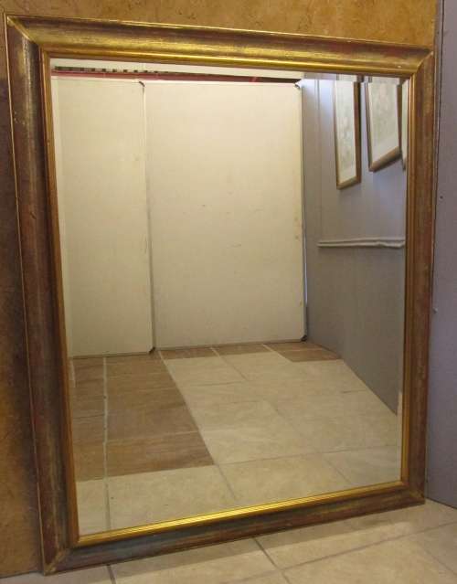 A stylish large wall mirror with a stunning gold frame. Perfect in a large room