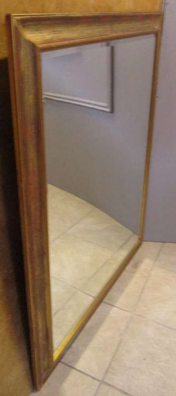 A stylish large wall mirror with a stunning gold frame. Perfect in a large room