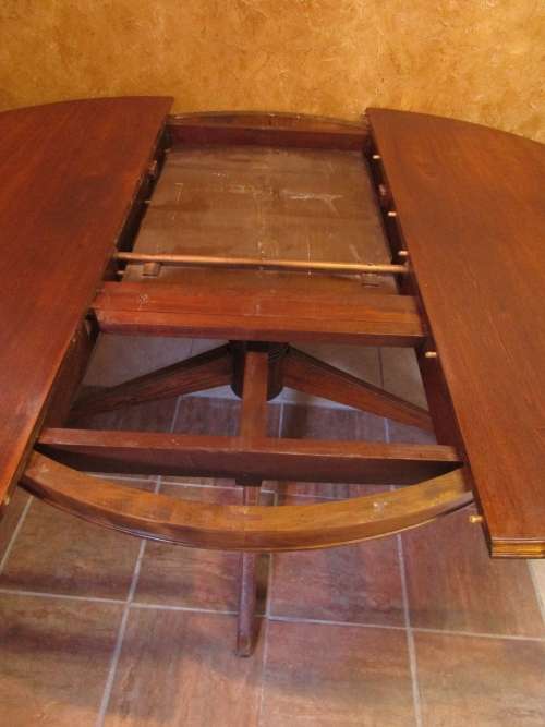 A VERY LARGE OVAL TO ROUND EXTENDABLE TABLE WITH BEAUTIFUL LEGS