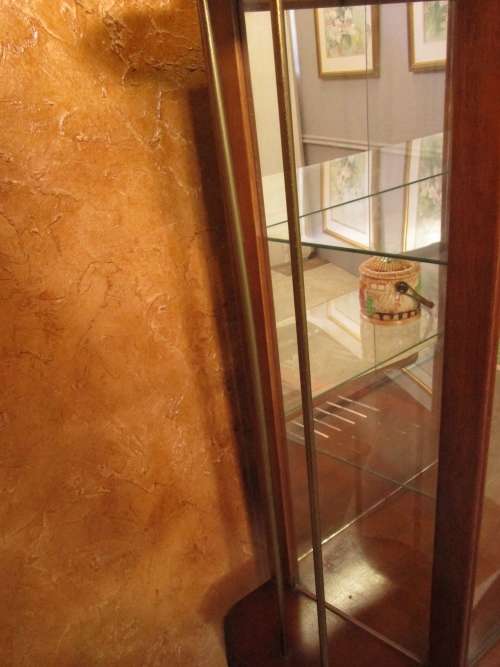 A VERY DIFFERENT IMBUIA BALL & CALW GLASS CABINET WITH A MIRROR AT THE BACK FINISHED OF WITH BRASS