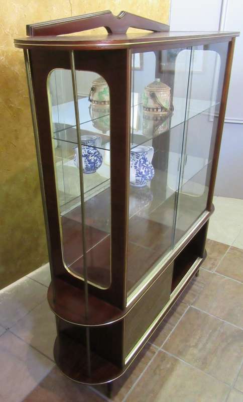 A VERY DIFFERENT IMBUIA BALL & CALW GLASS CABINET WITH A MIRROR AT THE BACK FINISHED OF WITH BRASS