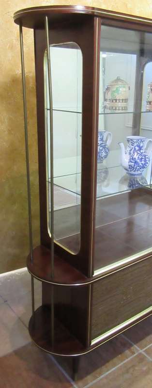 A VERY DIFFERENT IMBUIA BALL & CALW GLASS CABINET WITH A MIRROR AT THE BACK FINISHED OF WITH BRASS