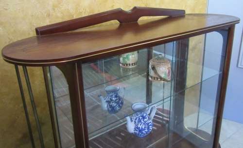 A VERY DIFFERENT IMBUIA BALL & CALW GLASS CABINET WITH A MIRROR AT THE BACK FINISHED OF WITH BRASS