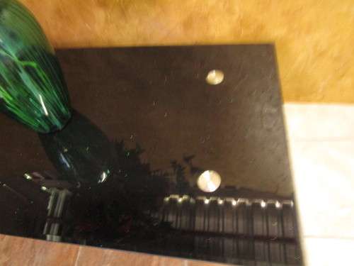A MODERN STYLE BLACK GLASS AND STAINLESS STEEL COFFEE TABLE