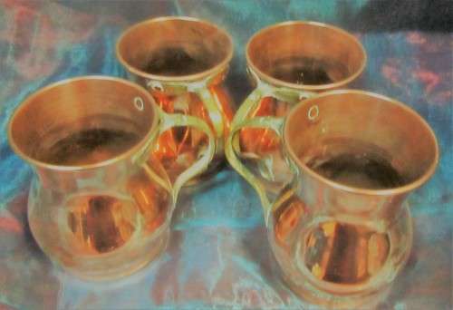 Four attractive antique tin-lined half pint copper mug or tankard with a brass handle.