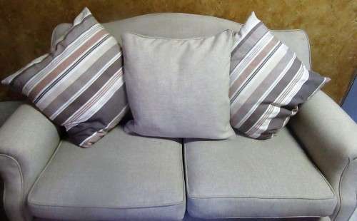 A VERY COMFORTABLE 2 SEATER COUCH IN GOOD CONDITTION