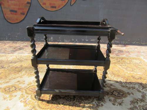 Three-tier tea trolley with barley twist legs and serving tray with a top glass top.