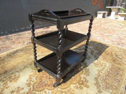 Three-tier tea trolley with barley twist legs and serving tray with a top glass top.