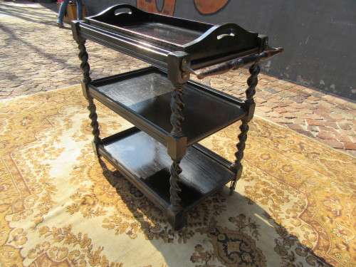 Three-tier tea trolley with barley twist legs and serving tray with a top glass top.