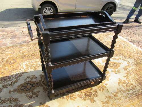 Three-tier tea trolley with barley twist legs and serving tray with a top glass top.