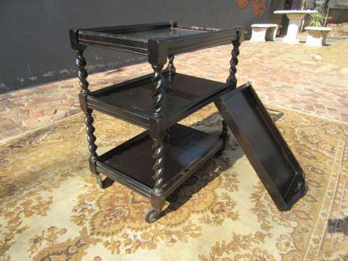 Three-tier tea trolley with barley twist legs and serving tray with a top glass top.