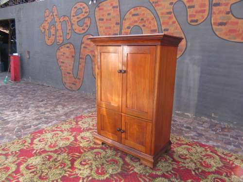 Four-door Mahogany cupboard with beautiful crown molding on top