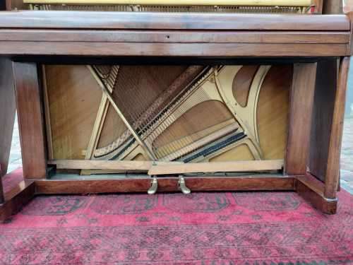 Danemann upright piano in teak cabinetry is a brilliant upright piano