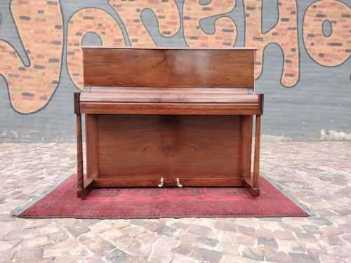 Danemann upright piano in teak cabinetry is a brilliant upright piano