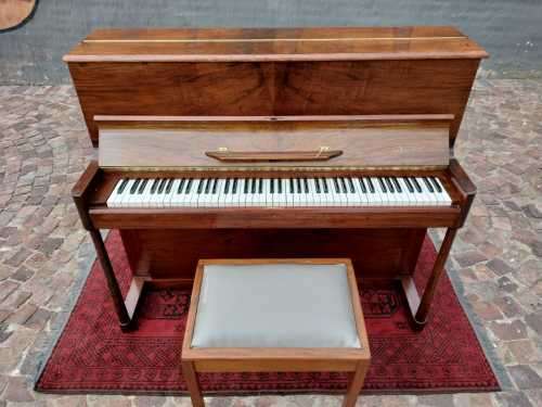 Danemann upright piano in teak cabinetry is a brilliant upright piano
