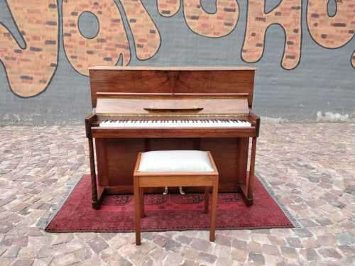 Danemann upright piano in teak cabinetry is a brilliant upright piano