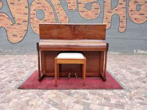 Danemann upright piano in teak cabinetry is a brilliant upright piano