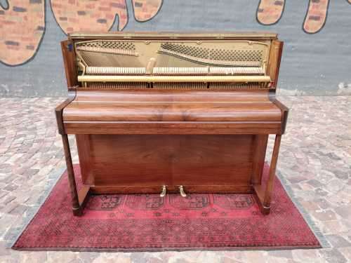 Danemann upright piano in teak cabinetry is a brilliant upright piano
