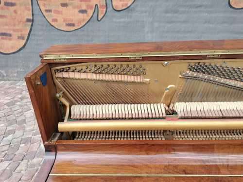 Danemann upright piano in teak cabinetry is a brilliant upright piano