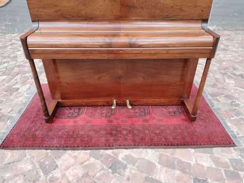 Danemann upright piano in teak cabinetry is a brilliant upright piano
