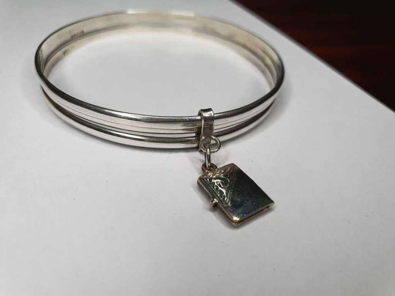 Trio of sterling silver bangles with a locket