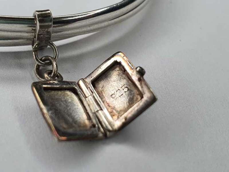 Trio of sterling silver bangles with a locket