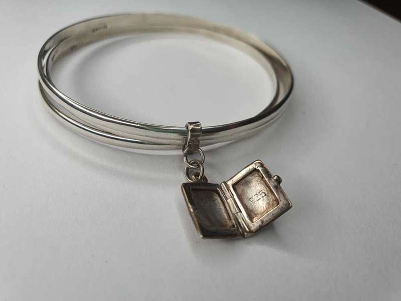 Trio of sterling silver bangles with a locket