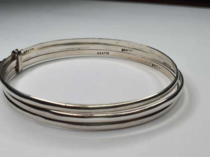 Trio of sterling silver bangles with a locket