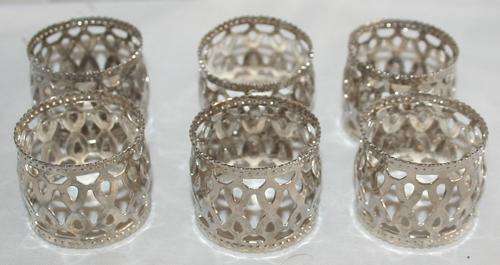 A MAGNIFICENT COLLECTION OF SIX SILVER PLATED PIERCED SERVIETTE RINGS