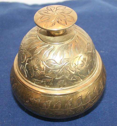 AN EXQUISITE HAND ENGRAVED BRASS CLAW BELL IN IT'S ORIGINAL BRASS HOLDER