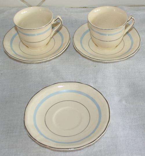 TWO SUPERB DEMITASSE ALFRED MEAKIN CUPS WITH SAUCERS WITH A BEAUTIFUL BLUE TRIM AND A EXTRA SAUSER