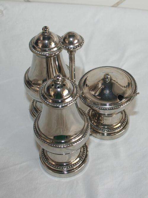 AN STYLISH THREE PIECE SILVER PLATED  CRUET SET ON STAND - SALT - PEPPER - LIDDED MUSTARD POT