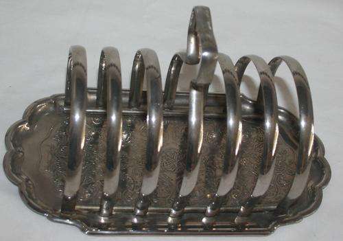 AN SUPER SILVER METAL TOAST RACK WITH BEAUTIFUL EMBOSSED DETAIL NOT MARKED LOOK LIKE EPNS