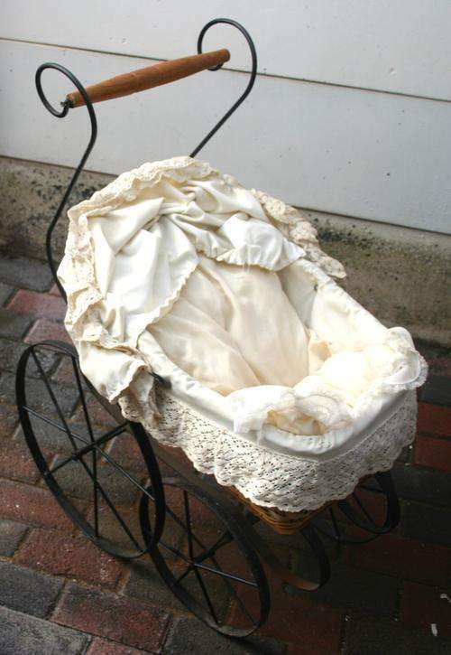 AN GORGEOUS VINTAGE STEEL PRAM WITH A WOVEN BASKET WITH THE ORIGINAL FABRIC FINISH