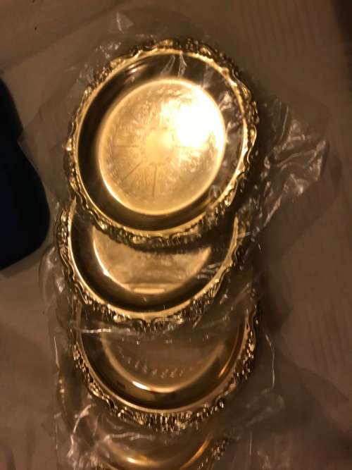 Set of brass coasters for auction