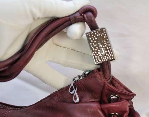 GENUINE JENNIFER LOPEZ (JLO) BURGUNDY ORIGINAL LEATHER 'HOBO' HANDBAG WITH TASSEL DETAILS.