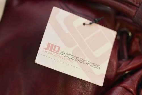 GENUINE JENNIFER LOPEZ (JLO) BURGUNDY ORIGINAL LEATHER 'HOBO' HANDBAG WITH TASSEL DETAILS.