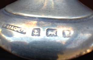 THESE ARE THE MARKINGS ON THE CANDLESTICK HOLDER AND IT IS SLIGHTLY BENT AT THE TOP OF THE HOLDER ON THE SCOLLOP. 