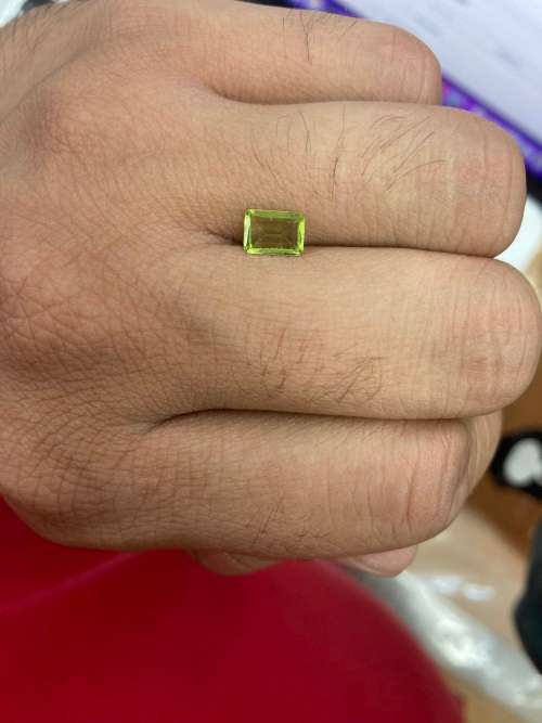 0.8cts Natural Mined Peridot. Emerald cut. 6.9mm x 4.9mm. Superb cut and polish. VVS