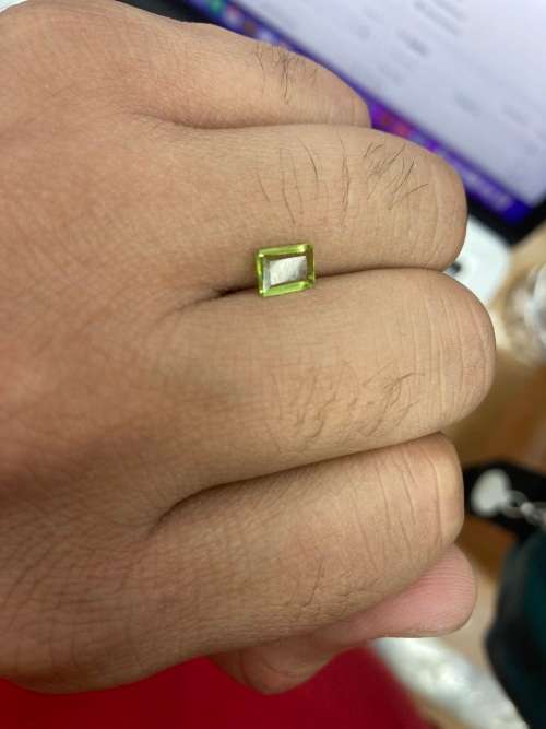 0.8cts Natural Mined Peridot. Emerald cut. 6.9mm x 4.9mm. Superb cut and polish. VVS