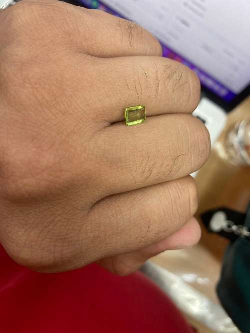 0.8cts Natural Mined Peridot. Emerald cut. 6.9mm x 4.9mm. Superb cut and polish. VVS