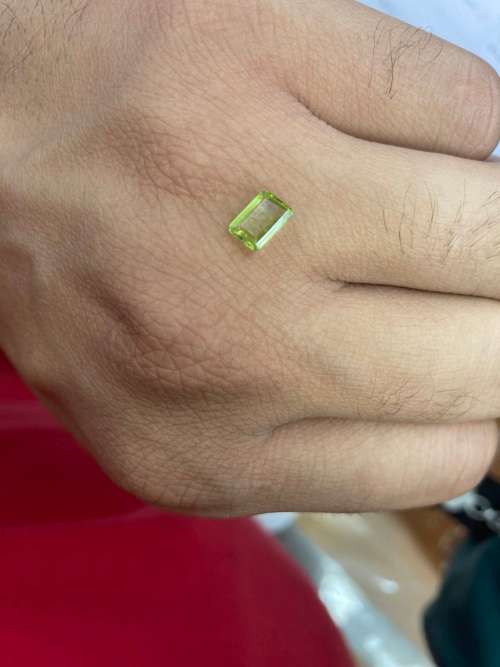 0.8cts Natural Mined Peridot. Emerald cut. 6.9mm x 4.9mm. Superb cut and polish. VVS