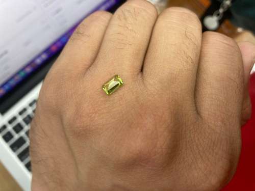 0.8cts Natural Mined Peridot. Emerald cut. 6.9mm x 4.9mm. Superb cut and polish. VVS